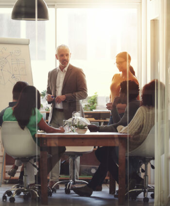 Shot of a group of coworkers in a boardroom meeting.